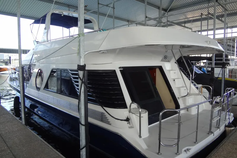 Slide: The Image of 2008 Bluewater 5200 Signature Edition yacht docked in a covered marina. - 7