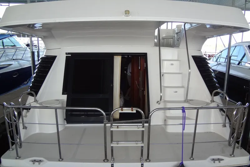 Slide: The Image of 2008 Bluewater 5200 Signature Edition yacht, rear view with ladder and railing. - 8