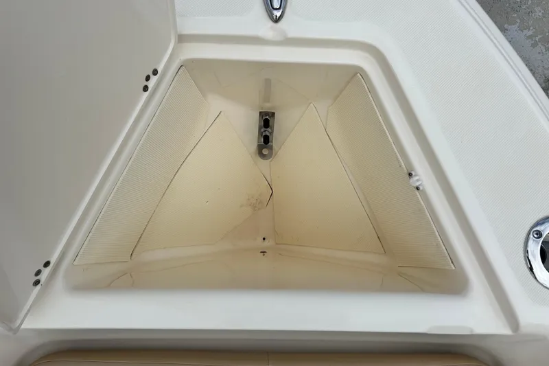 Slide: The Image of Storage compartment of a 2021 Scout 175 Dorado boat, featuring a clean, triangular design. - 21