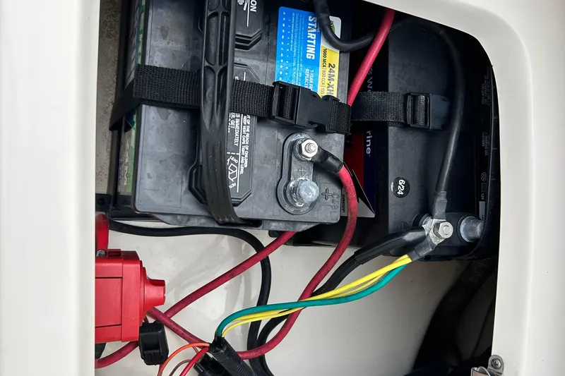 Slide: The Image of 2021 Scout 175 Dorado boat battery compartment with wiring and connections. - 26