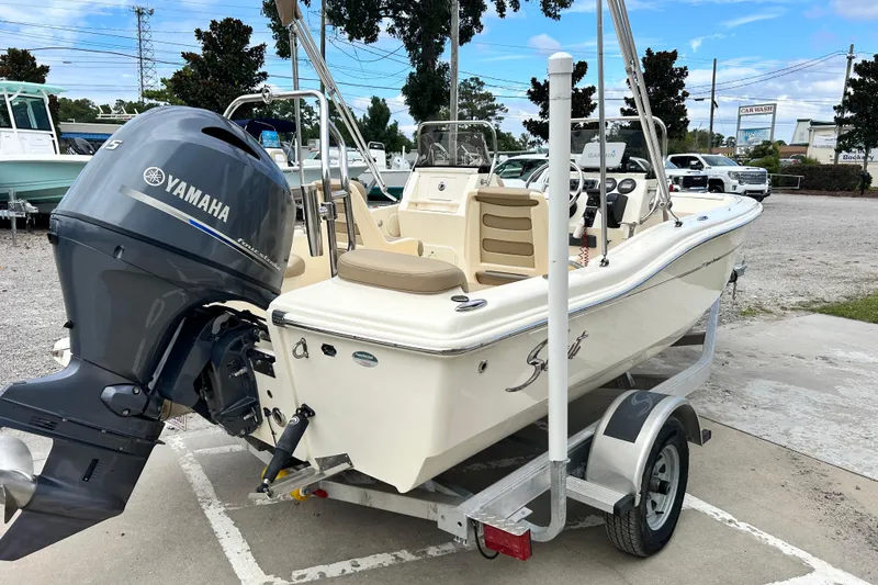 Slide: The Image of 2021 Scout 175 Dorado boat with Yamaha engine on trailer, parked outdoors. - 3