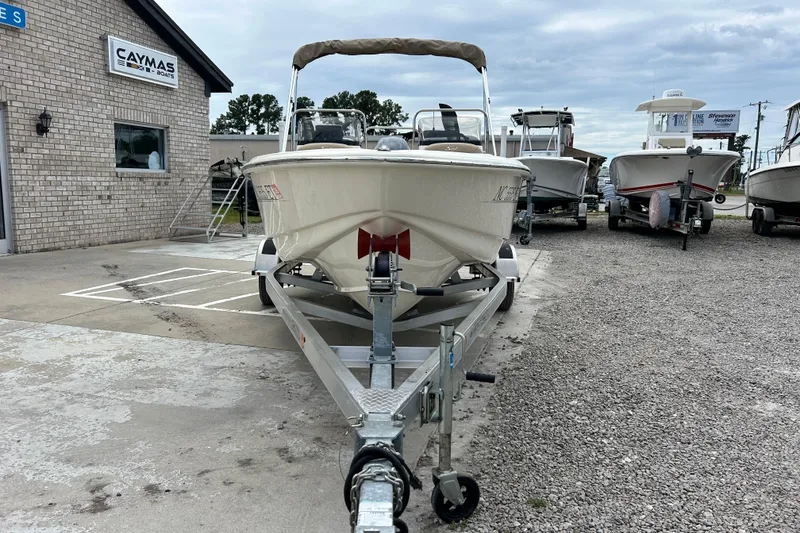 Slide: The Image of 2021 Scout 175 Dorado boat on trailer at dealership, surrounded by other boats. - 5