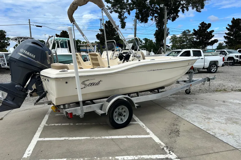 Slide: The Image of 2021 Scout 175 Dorado boat on trailer with Yamaha outboard motor in parking lot. - 6
