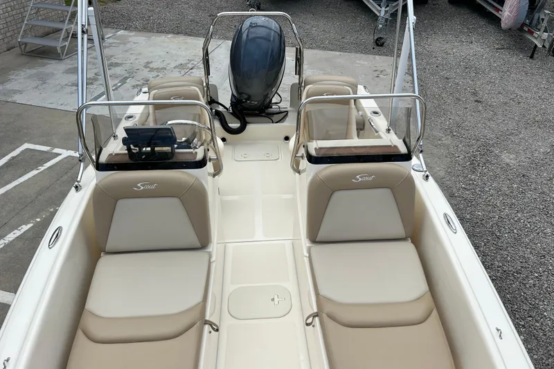 Slide: The Image of 2021 Scout 175 Dorado boat interior with beige seating and outboard motor. - 9