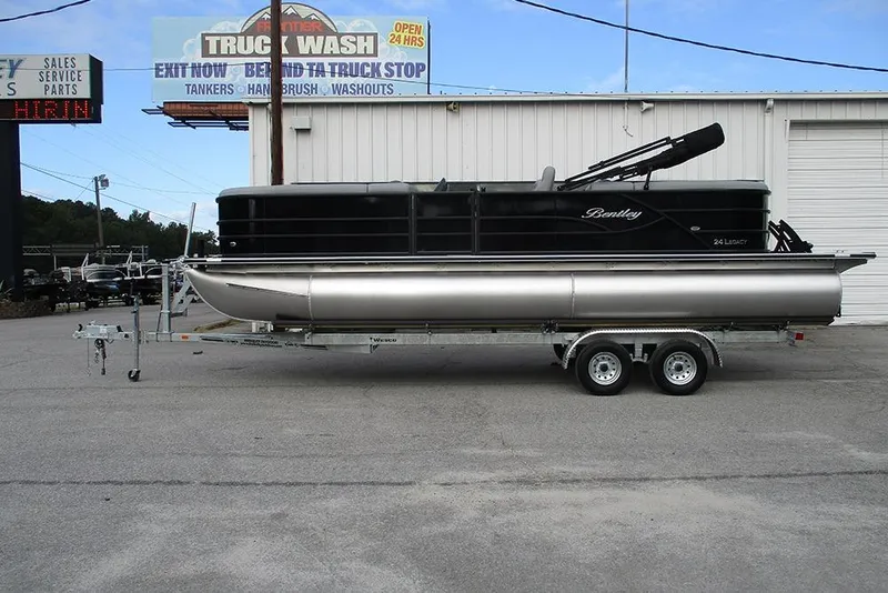 The Image of 2026 Bentley Pontoons Legacy 240 Navigator on trailer outside truck wash. - 1