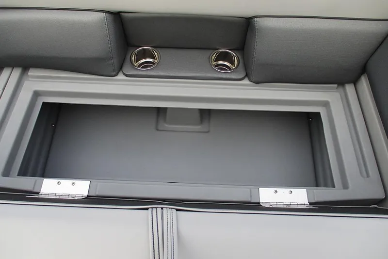 Slide: The Image of 2026 Bentley Pontoons Legacy 240 Navigator storage compartment with cup holders, gray interior. - 17