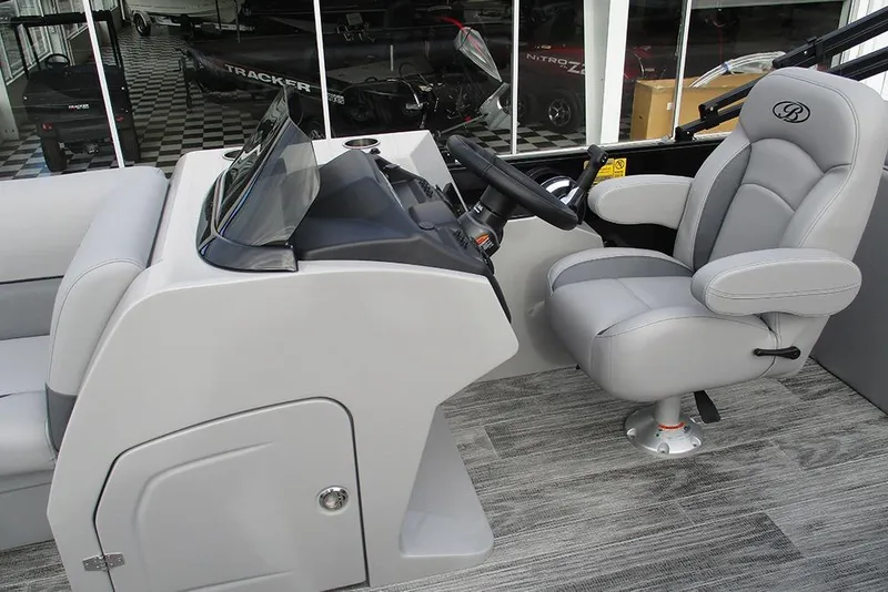 Slide: The Image of 2026 Bentley Pontoons Legacy 240 Navigator helm with sleek gray seating and modern controls. - 29