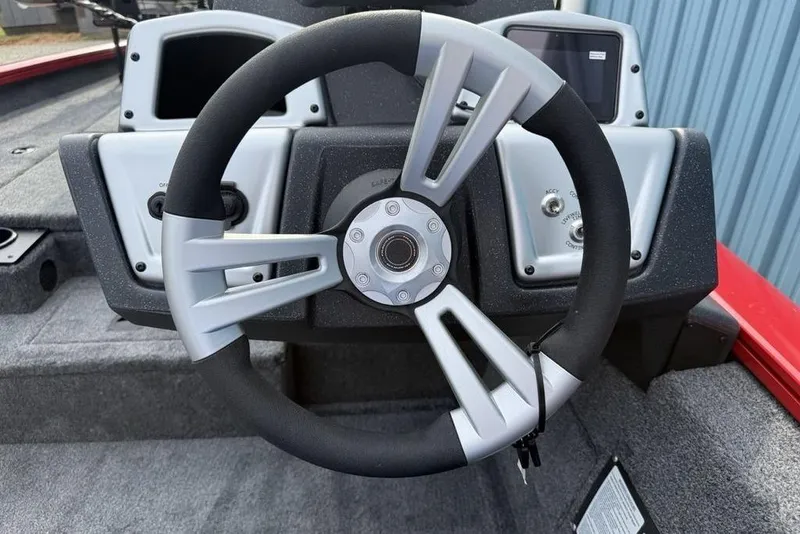 Slide: The Image of Steering wheel of 2026 Tracker Pro Team 175 boat, featuring modern dashboard controls. - 14