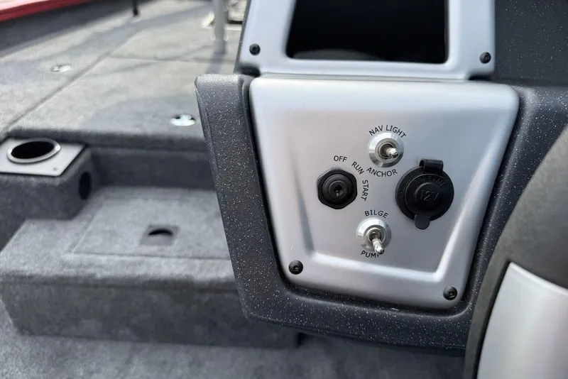 Slide: The Image of Control panel of 2026 Tracker Pro Team 175 boat with switches and outlets. - 16