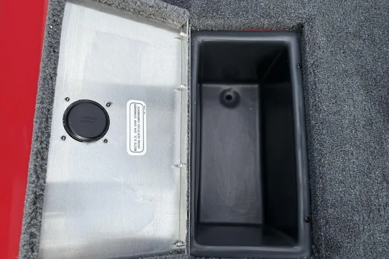 Slide: The Image of Open storage compartment in 2026 Tracker Pro Team 175 boat, featuring carpeted interior. - 17