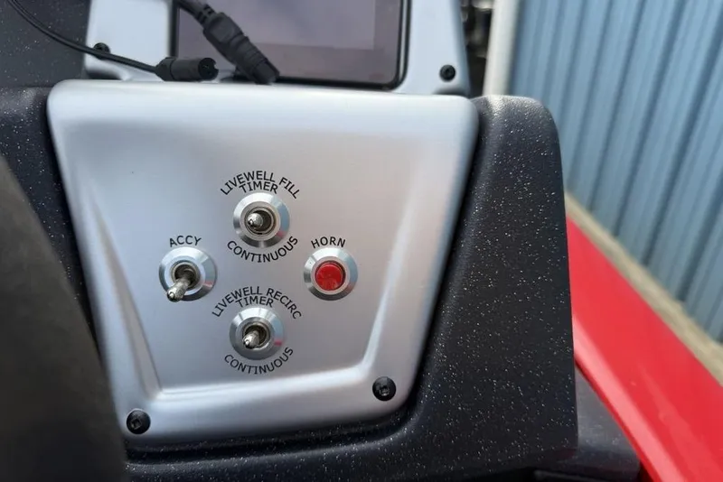Slide: The Image of Control panel of 2026 Tracker Pro Team 175 boat with switches and horn button. - 19
