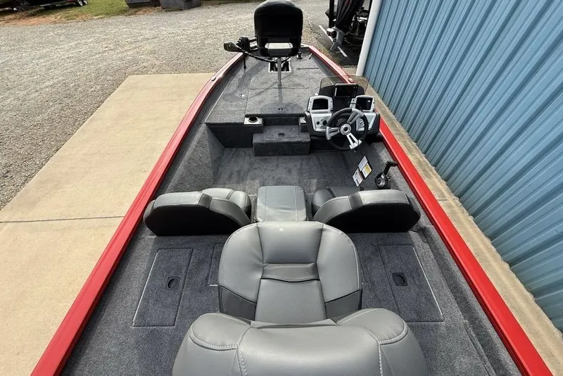 Slide: The Image of 2026 Tracker Pro Team 175 boat interior with gray seating and steering console. - 24