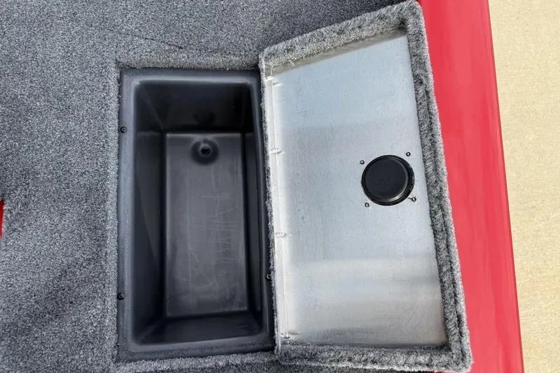Slide: The Image of Open storage compartment on 2026 Tracker Pro Team 175 boat, featuring carpeted interior. - 26