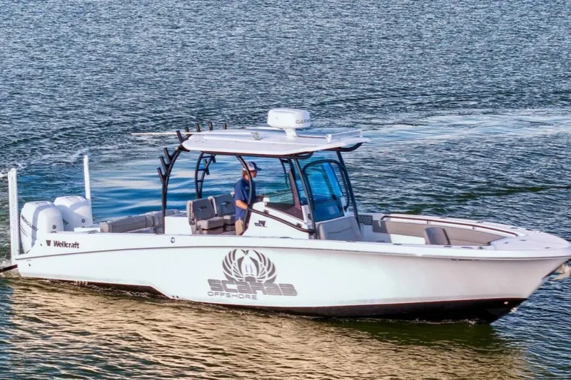 The Image of 2021 Wellcraft 302 Scarab boat cruising on open water. - 1