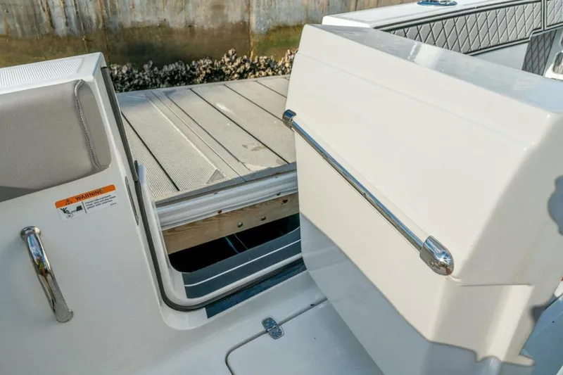 Slide: The Image of 2021 Wellcraft 302 Scarab boat with open side door, dockside view. - 10