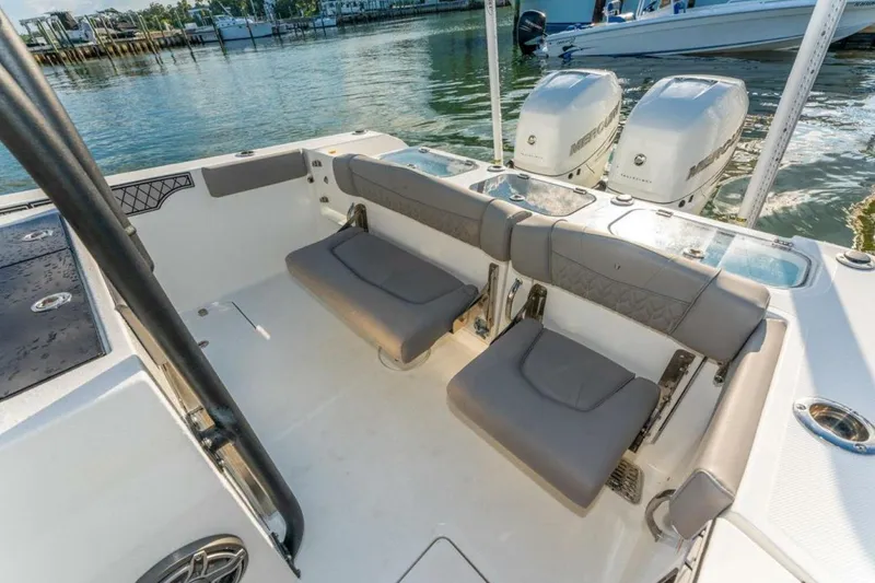 Slide: The Image of 2021 Wellcraft 302 Scarab boat interior with seating and dual Mercury engines. - 5