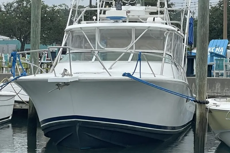 The Image of 1997 Luhrs 36 SX boat docked at marina, front view with clear skies. - 0