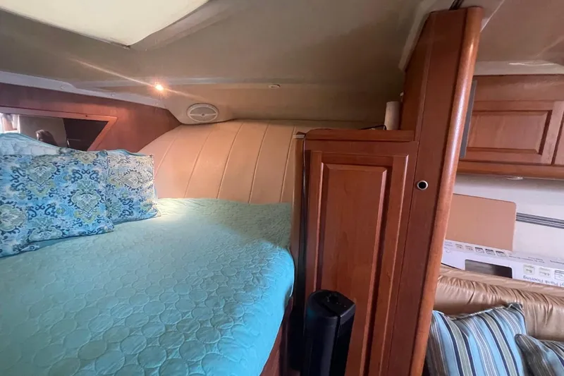 Slide: The Image of Interior of 1997 Luhrs 36 SX boat with cozy bed and wooden cabinetry. - 15
