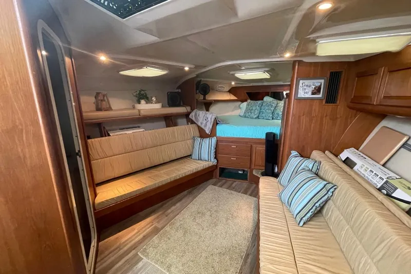 Slide: The Image of 1997 Luhrs 36 SX yacht interior with cozy seating, wood finish, and a comfortable bed. - 20