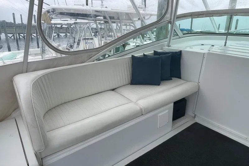 Slide: The Image of 1997 Luhrs 36 SX boat interior with white seating and blue cushions. - 26