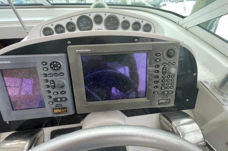 Slide: The Image of 1997 Luhrs 36 SX boat dashboard with Furuno navigation systems and gauges. - 29