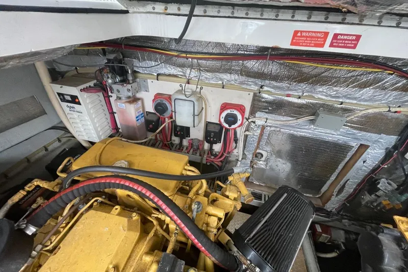 Slide: The Image of Engine room of a 1997 Luhrs 36 SX boat, featuring mechanical components and wiring. - 41