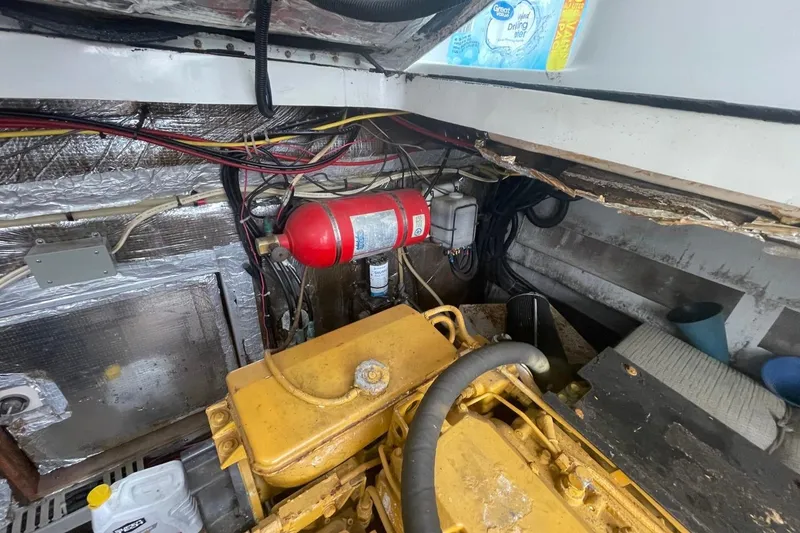 Slide: The Image of Engine room of a 1997 Luhrs 36 SX boat, featuring wiring and fire extinguisher. - 42
