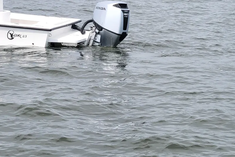 Slide: The Image of 2025 C-Hawk 23CC boat with Honda outboard motor on water. - 10