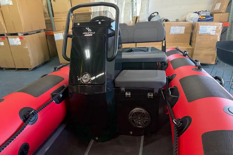 Slide: The Image of 2023 Highfield Classic 380 FCT inflatable boat with red and black design in warehouse setting. - 4