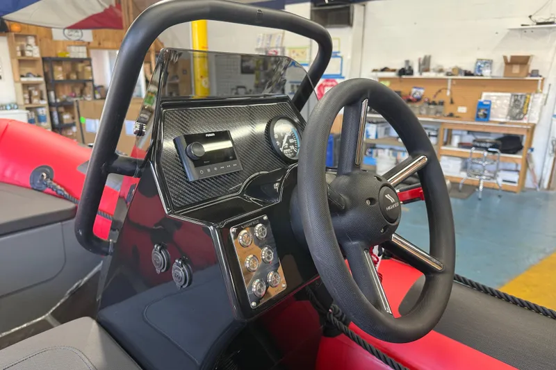 Slide: The Image of 2023 Highfield Classic 380 FCT boat dashboard with steering wheel and control panel. - 6