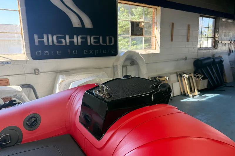 Slide: The Image of 2023 Highfield Classic 380 FCT boat in showroom, featuring red and black design. - 9