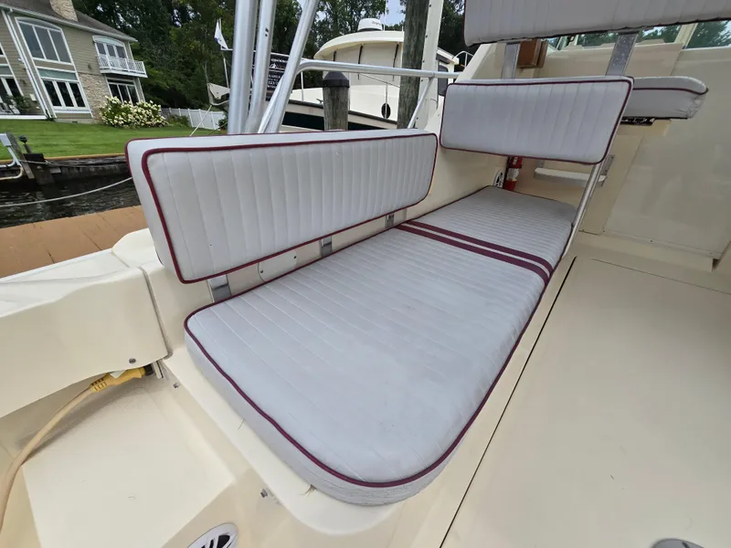 Slide: The Image of 2001 Mainship Pilot 30 Sedan interior with cushioned seating and elegant design. - 12