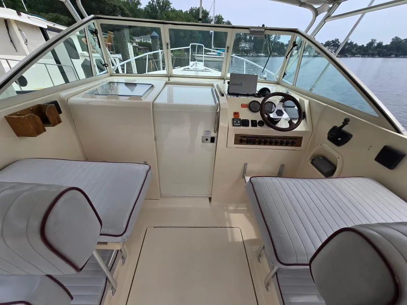 Slide: The Image of 2001 Mainship Pilot 30 Sedan cockpit with steering wheel, seating, and navigation equipment. - 13