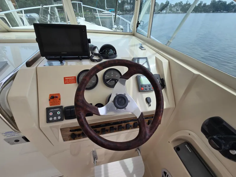 Slide: The Image of 2001 Mainship Pilot 30 Sedan helm with steering wheel and navigation equipment. - 15
