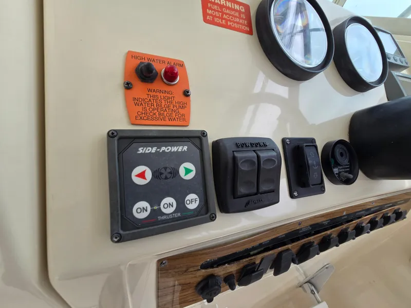 Slide: The Image of Control panel of a 2001 Mainship Pilot 30 Sedan with gauges and switches. - 17