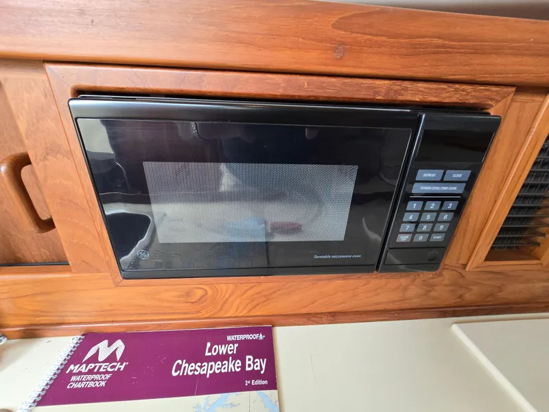 Slide: The Image of Microwave in 2001 Mainship Pilot 30 Sedan with Chesapeake Bay chartbook nearby. - 26