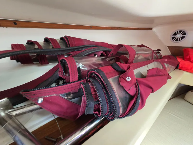 Slide: The Image of Red canvas covers stored inside a 2001 Mainship Pilot 30 Sedan boat. - 28