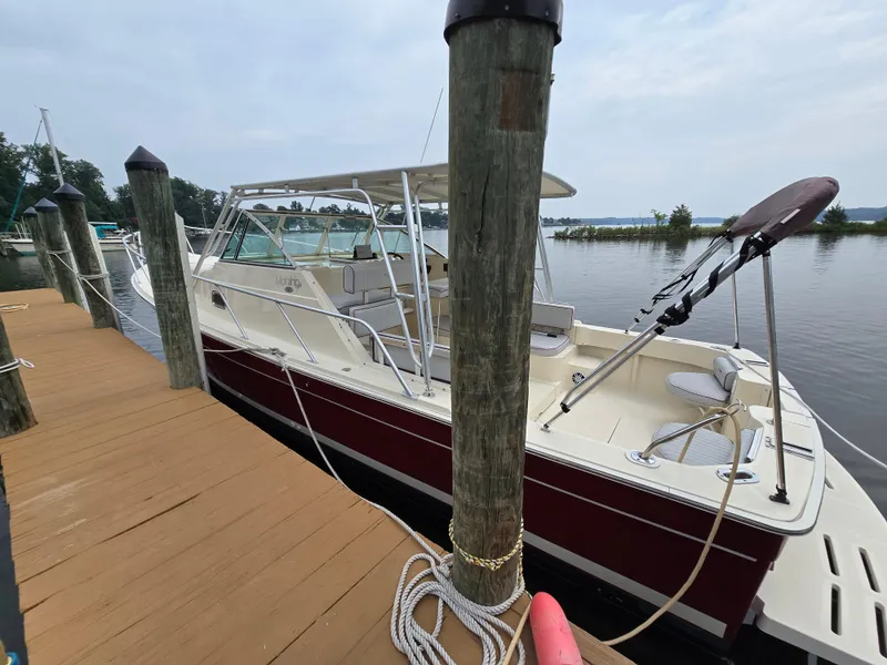 Slide: The Image of 2001 Mainship Pilot 30 Sedan docked at a marina, featuring a sleek design. - 35