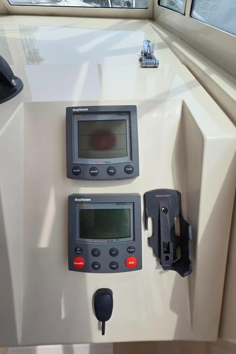 Slide: The Image of 2001 Mainship Pilot 30 Sedan dashboard with Raytheon navigation instruments. - 36