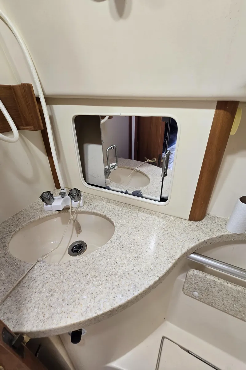 Slide: The Image of 2001 Mainship Pilot 30 Sedan bathroom with sink, mirror, and countertop. - 41