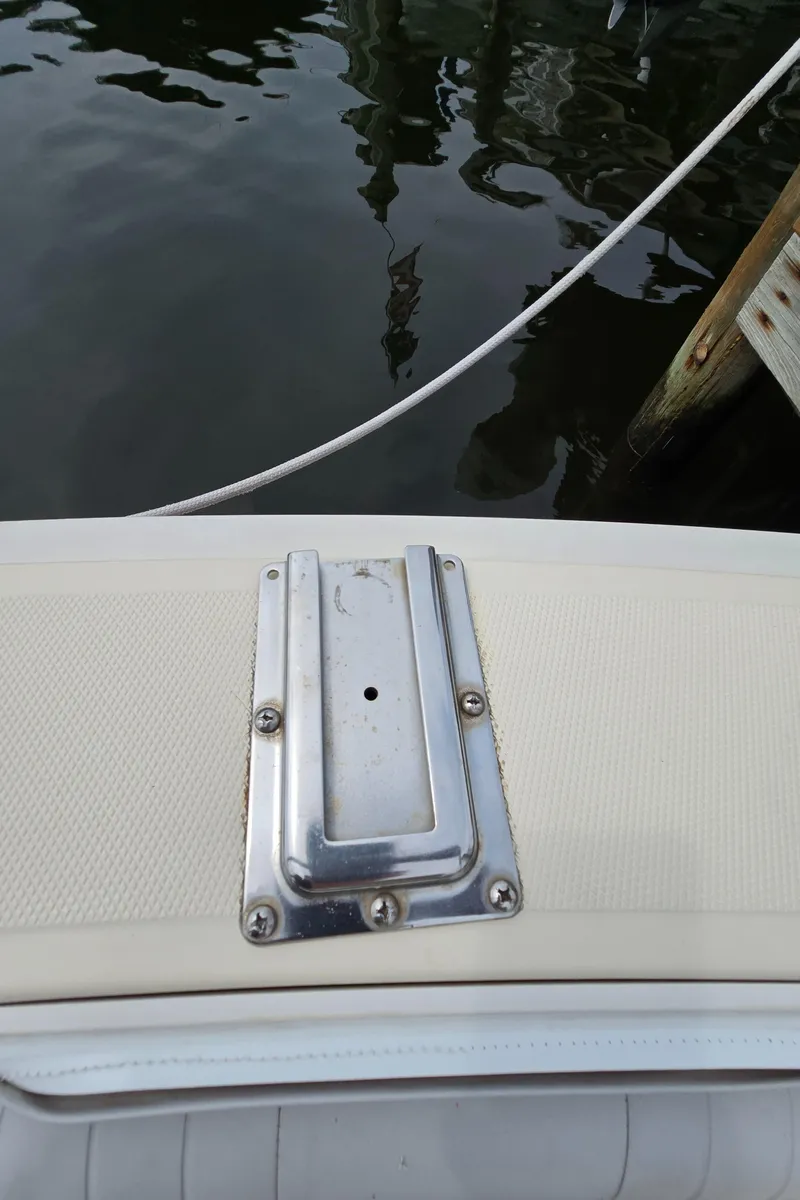 Slide: The Image of 2001 Mainship Pilot 30 Sedan boat detail with metal fixture, docked by water. - 48