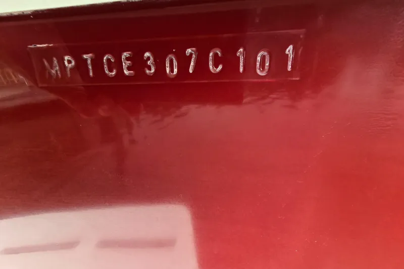 Slide: The Image of Hull identification number on a red 2001 Mainship Pilot 30 Sedan boat. - 49
