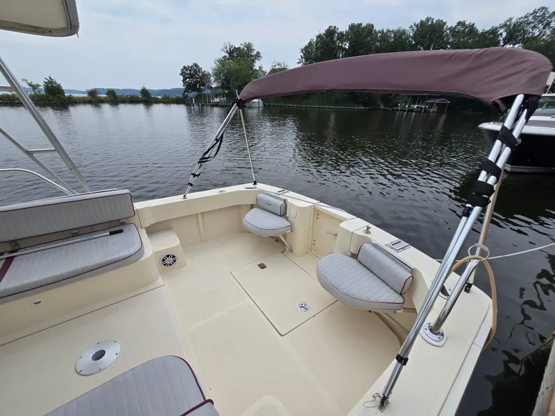 Slide: The Image of 2001 Mainship Pilot 30 Sedan boat with seating, canopy, and water view. - 5