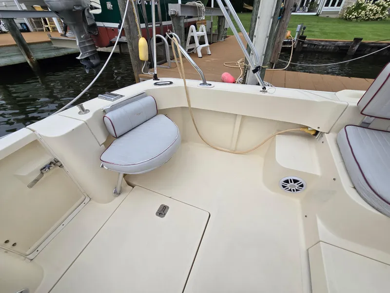 Slide: The Image of 2001 Mainship Pilot 30 Sedan boat interior with seating and dock view. - 8