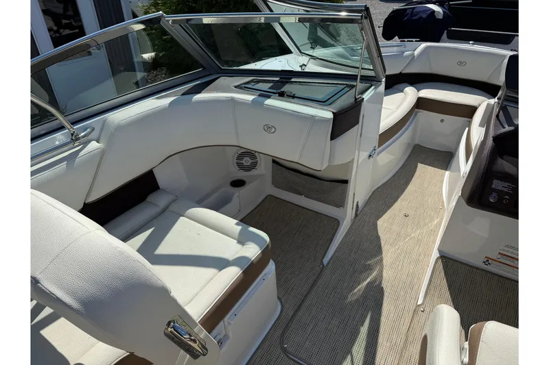 Slide: The Image of 2017 Cobalt 220S boat interior with white seating and beige flooring. - 10