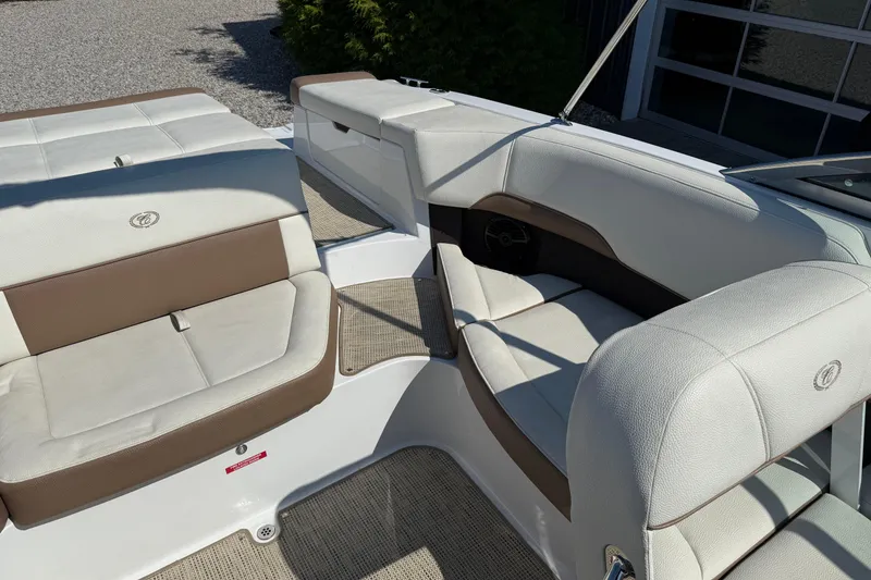 Slide: The Image of 2017 Cobalt 220S boat interior with white and brown seating. - 14
