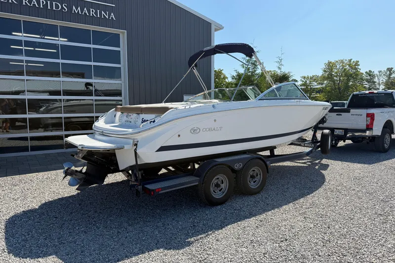 Slide: The Image of 2017 Cobalt 220S boat on trailer outside marina, sunny day. - 3