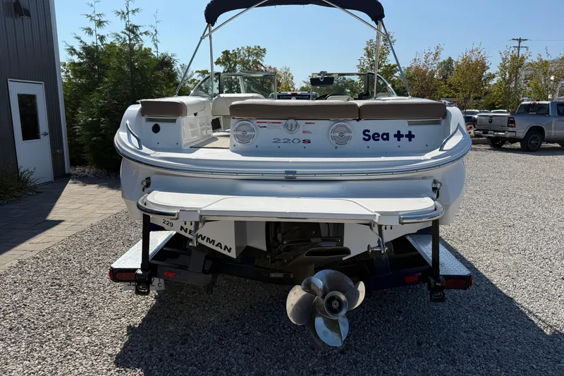 Slide: The Image of 2017 Cobalt 220S boat on trailer, rear view, parked on gravel. - 4