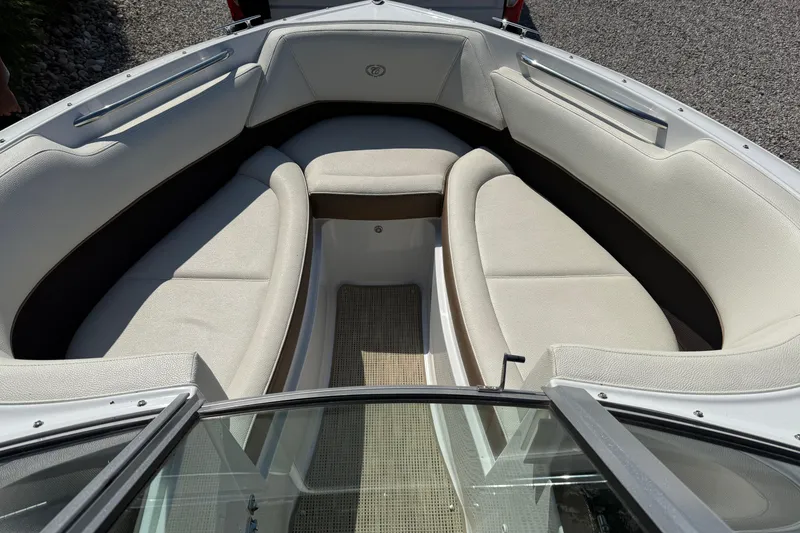 Slide: The Image of 2017 Cobalt 220S boat interior with beige seating and carpeted floor. - 9