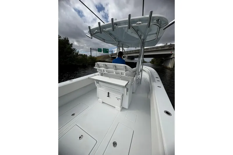 Slide: The Image of 2026 Contender 32 ST boat on water, featuring sleek design and spacious deck. - 11